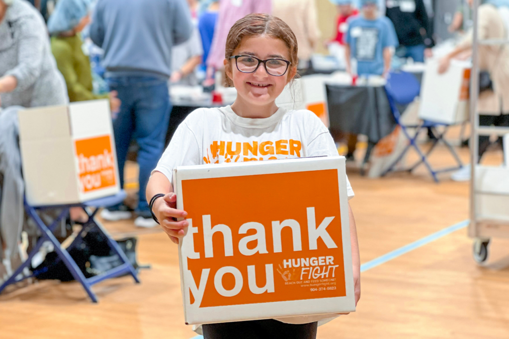 A girl holding a meal box